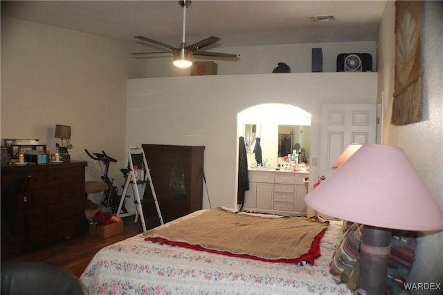 bedroom featuring vaulted ceiling, visible vents, and dark wood finished floors