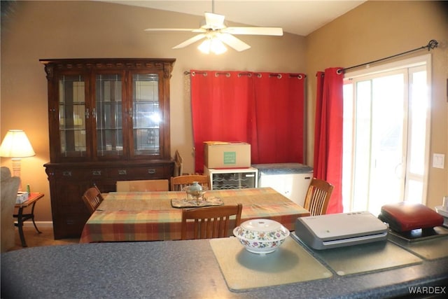 dining space featuring lofted ceiling and a ceiling fan