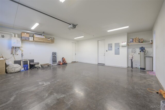 garage featuring water heater, electric panel, and a garage door opener