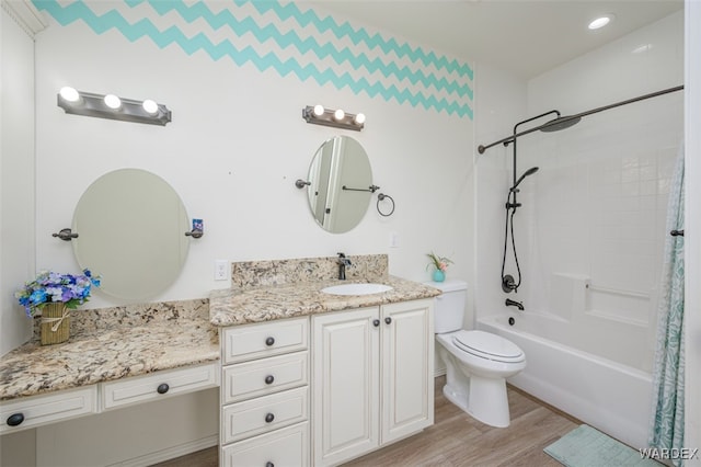 bathroom with toilet, shower / tub combo, wood finished floors, and vanity