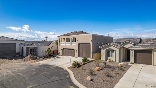 view of front facade with a tile roof, stucco siding, fence, a residential view, and driveway