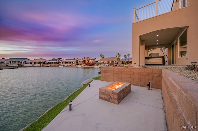 view of water feature featuring an outdoor fire pit and a residential view