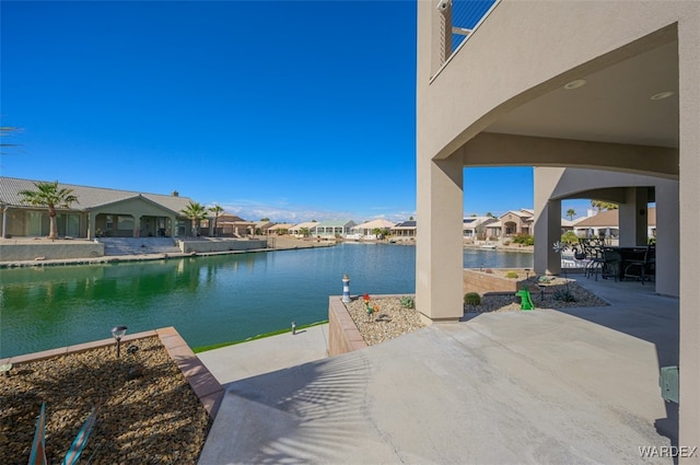 view of patio / terrace with a water view and a residential view