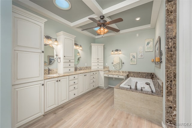 bathroom with wood finished floors, coffered ceiling, a sink, and a bath