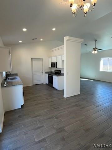 kitchen featuring white cabinets, dark wood-style floors, open floor plan, stainless steel appliances, and a sink