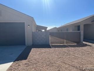 view of side of home featuring a gate and fence