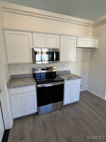 kitchen featuring appliances with stainless steel finishes, baseboards, white cabinetry, and dark wood-type flooring