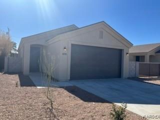 ranch-style house featuring a garage and driveway