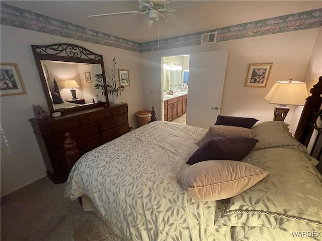 bedroom featuring carpet floors, ceiling fan, visible vents, and connected bathroom