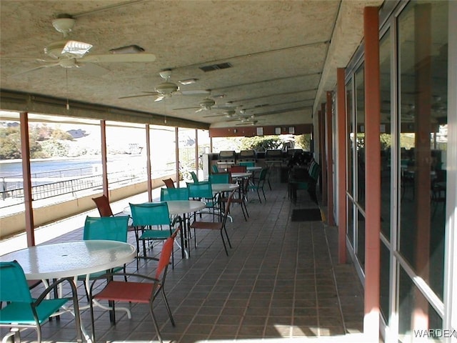 sunroom featuring ceiling fan and visible vents