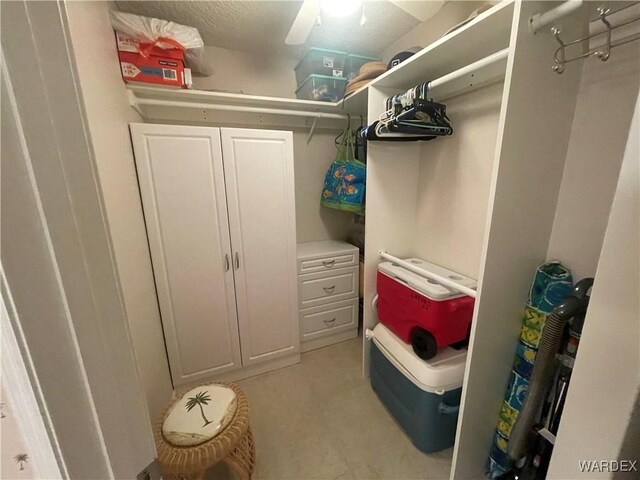 walk in closet with light floors