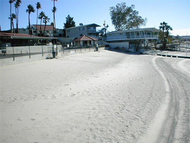 exterior space with fence and dirt driveway