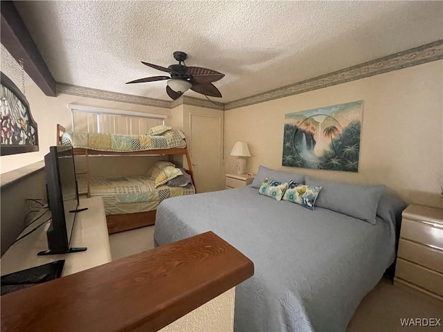 bedroom featuring a textured ceiling, ceiling fan, and crown molding