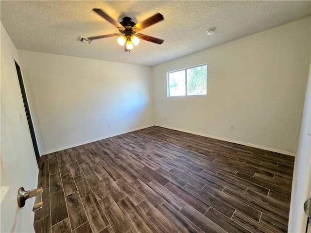 3166 E Thompson Ave, Kingman, AZ 86409 - spare room with dark wood-style floors, a ceiling fan, a textured ceiling, baseboards, and a smoke detector