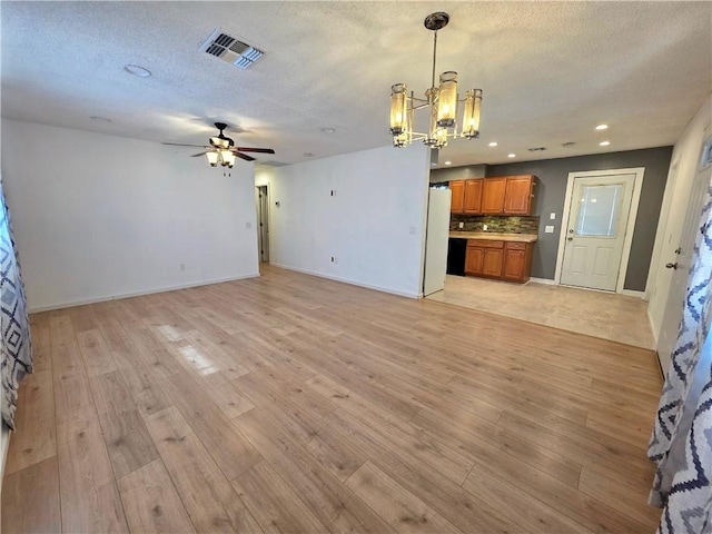 3166 E Thompson Ave, Kingman, AZ 86409 - unfurnished living room featuring a chandelier, ceiling fan, light wood-type flooring, a textured ceiling, and recessed lighting