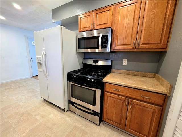 3166 E Thompson Ave, Kingman, AZ 86409 - kitchen featuring appliances with stainless steel finishes, brown cabinets, light countertops, and recessed lighting
