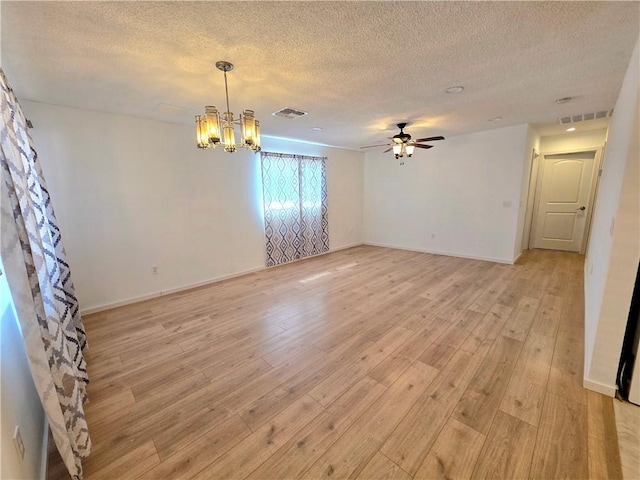 3166 E Thompson Ave, Kingman, AZ 86409 - empty room featuring a textured ceiling, a chandelier, ceiling fan, light wood-style flooring, and baseboards