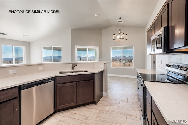 kitchen with visible vents, lofted ceiling, stainless steel appliances, dark brown cabinets, and a sink