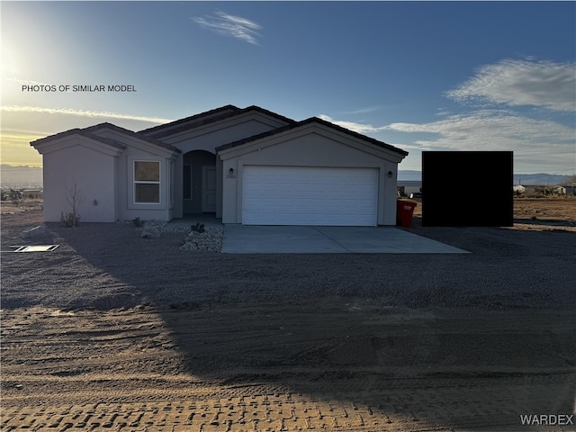 view of front of home with driveway and an attached garage