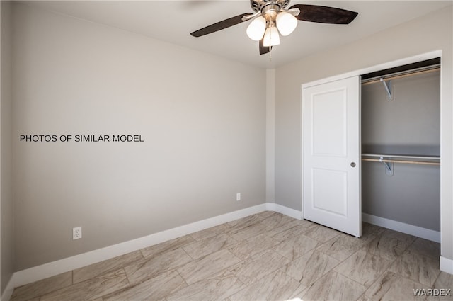 unfurnished bedroom featuring a closet, ceiling fan, marble finish floor, and baseboards