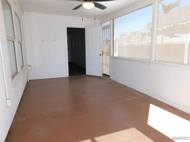 spare room featuring ceiling fan and finished concrete flooring