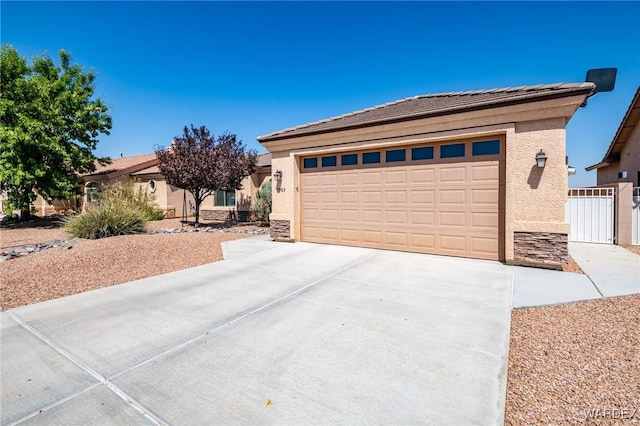 view of front of property featuring a garage, stone siding, concrete driveway, and stucco siding