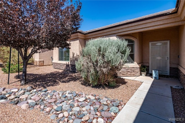 view of side of property with stone siding and stucco siding