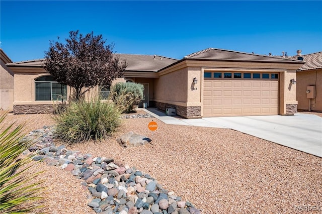 view of front of home featuring a tile roof, stucco siding, a garage, stone siding, and driveway