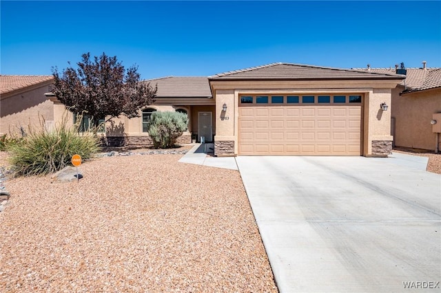 view of front of property featuring an attached garage, concrete driveway, stone siding, and stucco siding