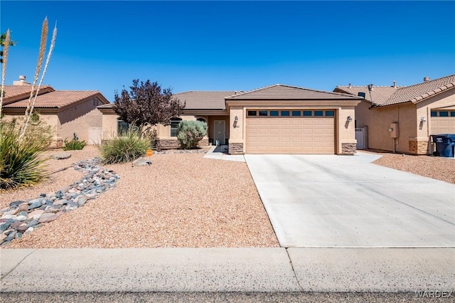 view of front of house with a garage, concrete driveway, a tiled roof, and stucco siding