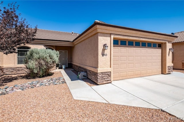 view of front of home with stucco siding, concrete driveway, an attached garage, stone siding, and a tiled roof