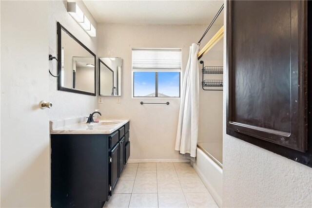 3741 June St, Bullhead City, AZ 86442 - full bathroom with vanity, shower / bathtub combination with curtain, tile patterned floors, and baseboards