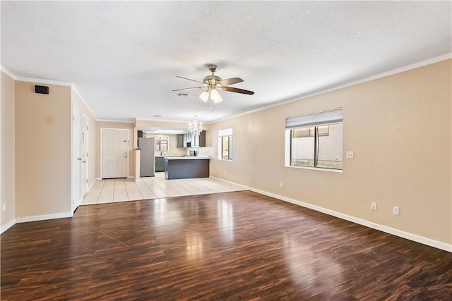 3741 June St, Bullhead City, AZ 86442 - unfurnished living room with a chandelier, crown molding, ceiling fan, light wood-style floors, and baseboards
