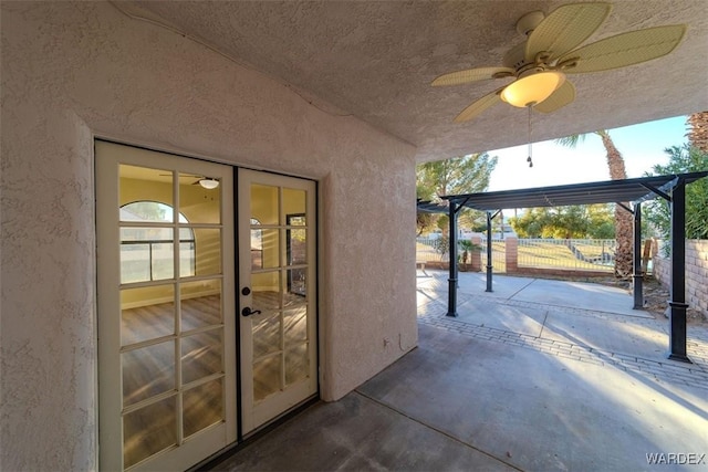 view of patio featuring a ceiling fan, fence, and a pergola