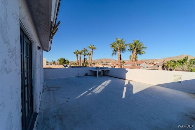 exterior space with a patio area, fence, and a mountain view