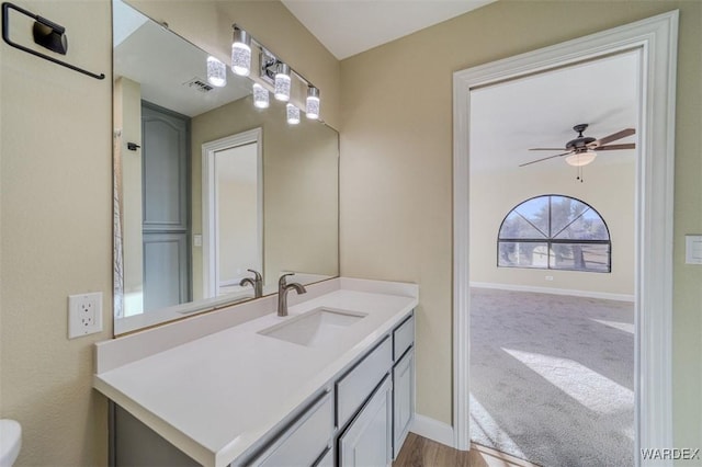 bathroom with a ceiling fan, visible vents, vanity, and baseboards