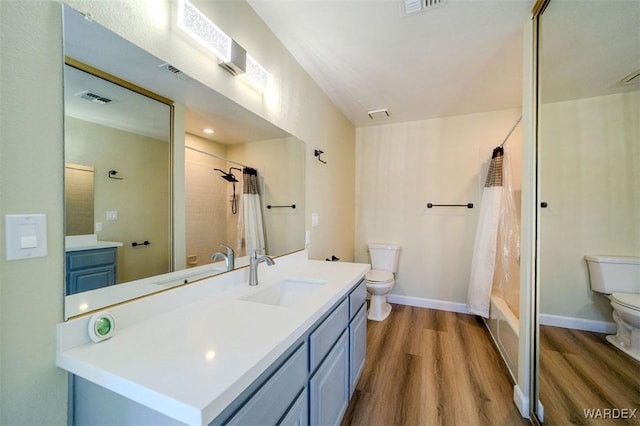 full bath with visible vents, wood finished floors, vanity, and toilet