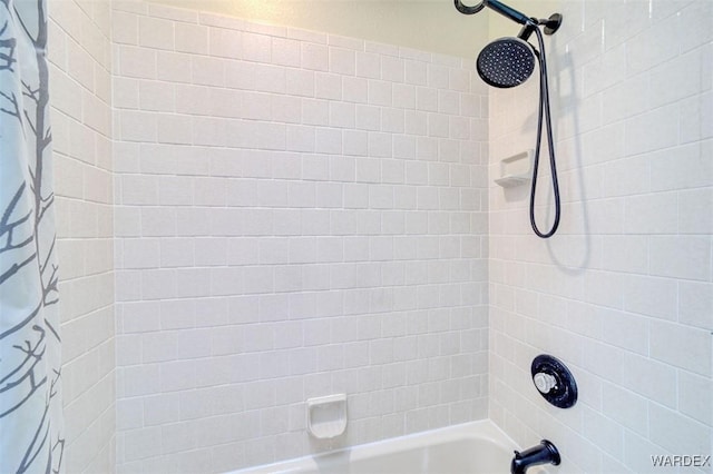 bathroom with shower / bath combo with shower curtain