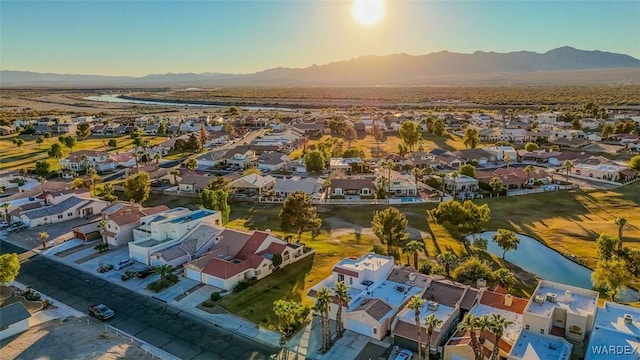 aerial view with a water and mountain view and a residential view