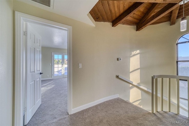 corridor with light carpet, visible vents, baseboards, wood ceiling, and an upstairs landing