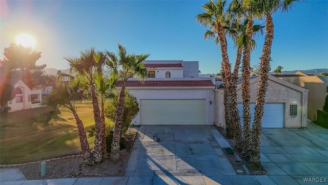 view of front of property featuring concrete driveway and stucco siding