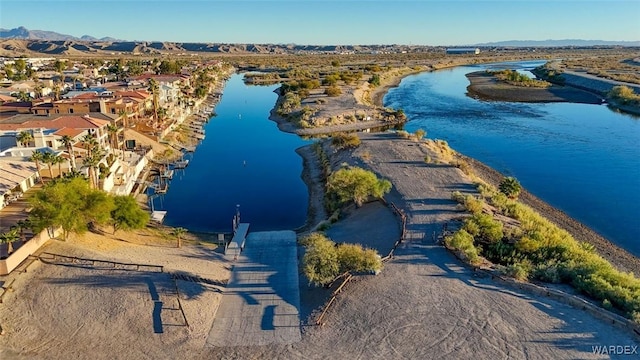 drone / aerial view featuring a residential view and a water and mountain view