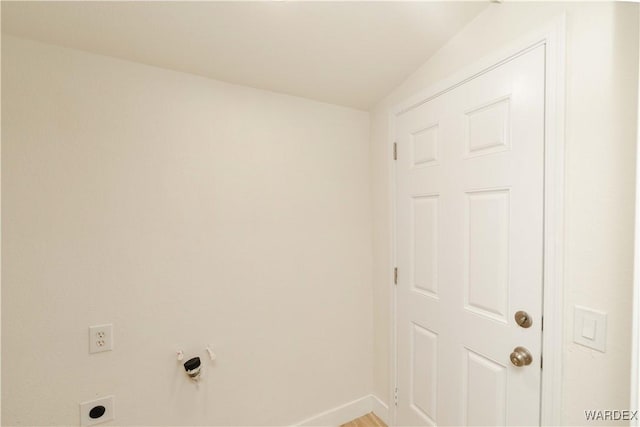 laundry room with laundry area, baseboards, and electric dryer hookup