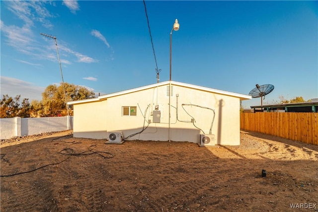 back of property with ac unit and a fenced backyard