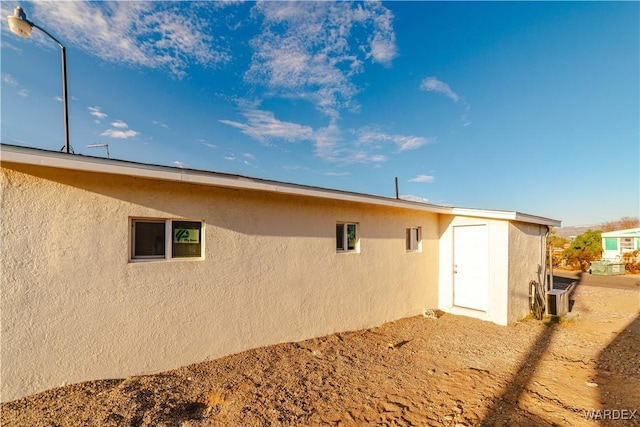 back of house with stucco siding