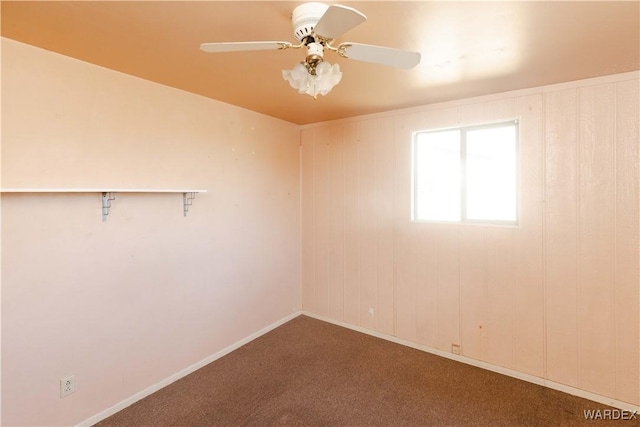 spare room featuring carpet floors, baseboards, and a ceiling fan