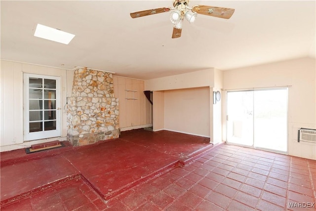 interior space featuring a wall mounted air conditioner, ceiling fan, and tile patterned floors