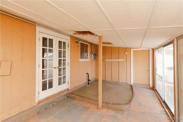 unfurnished sunroom with french doors