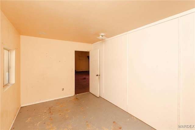 empty room featuring unfinished concrete floors