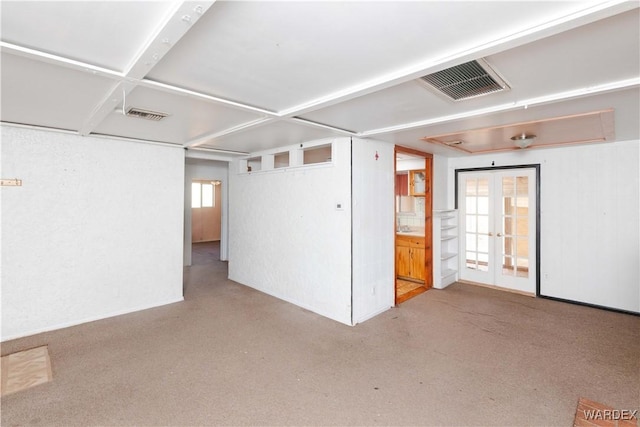 spare room featuring visible vents and french doors